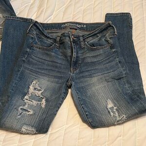 AE DESTRUCTED LOOK JEANS.
